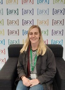 Hannah Kenton Visual Effects artist is pictured in front of a colour BFX logo banner